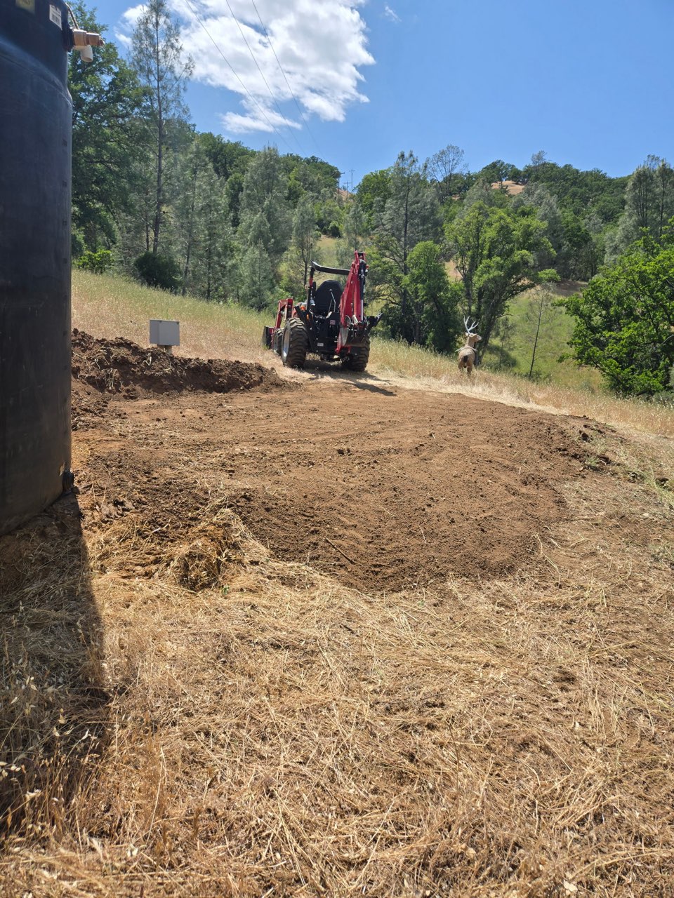 Hillside grading with backhoe